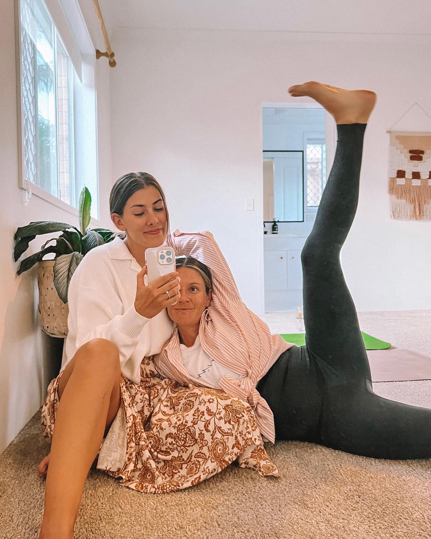 Pregnant mum stretching legs in TheRY Saviour Maternity Leggngs with compression