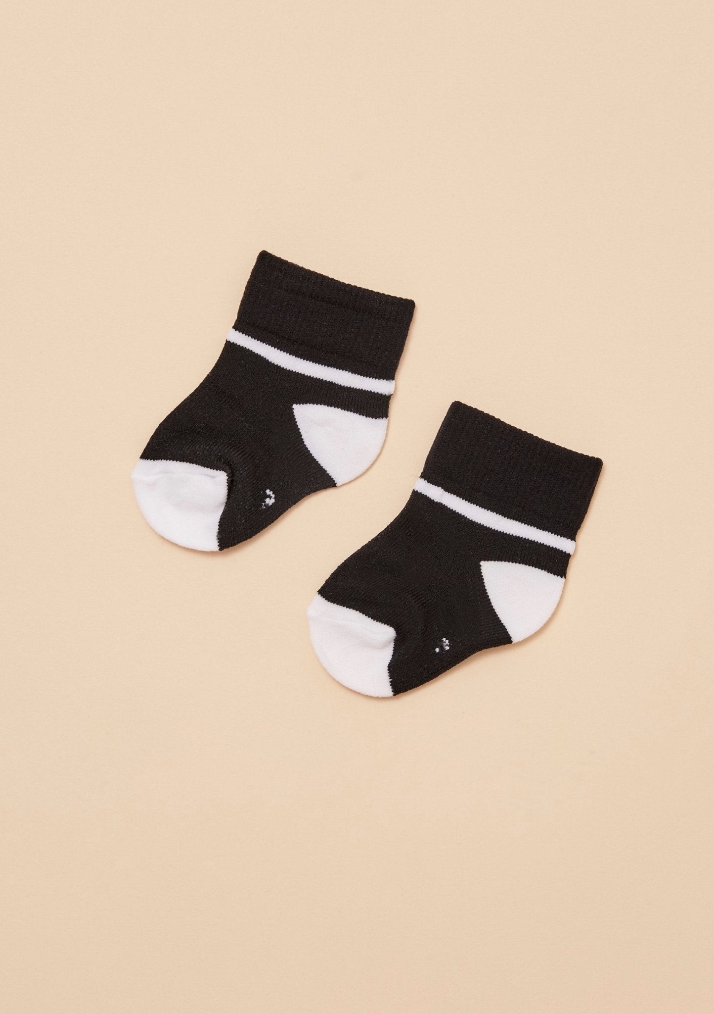 TheRY Black and white softest baby socks flatlay